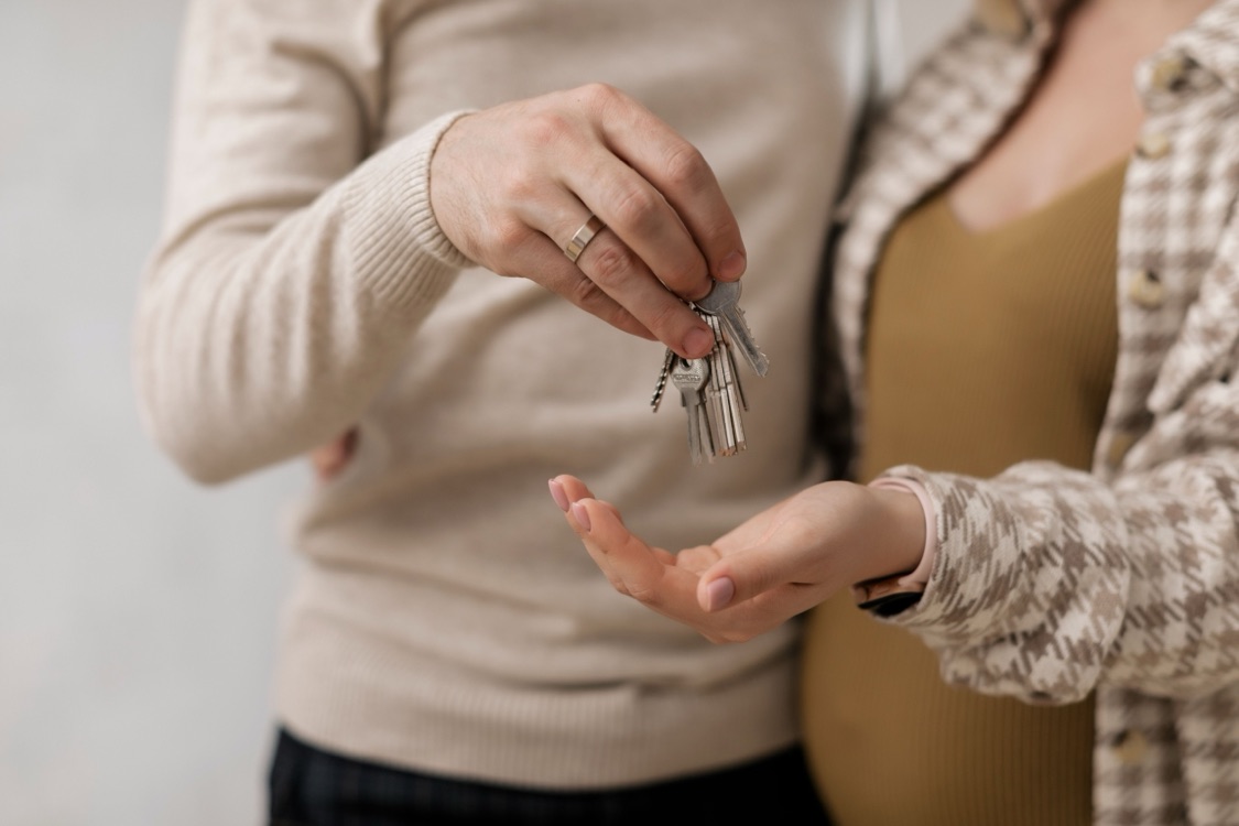 A couple being handed a set of house keys