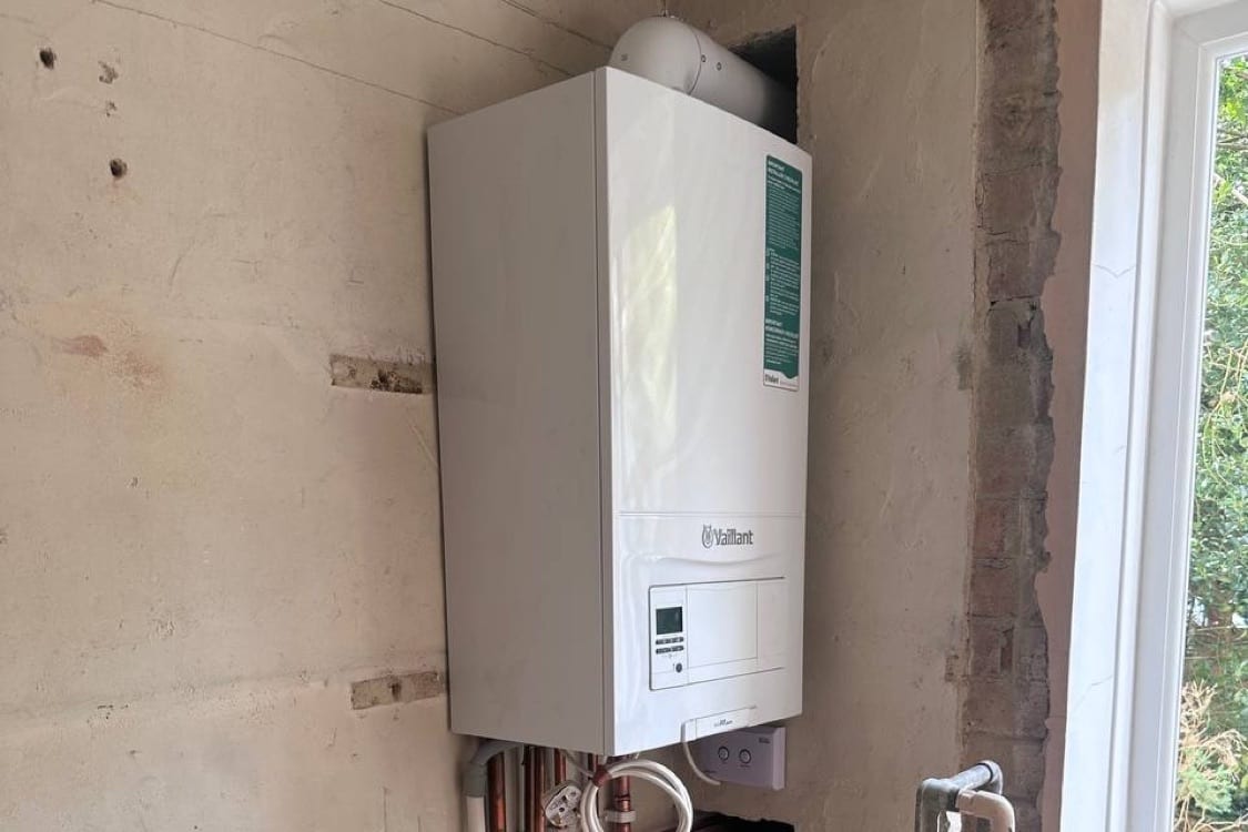 The live boiler relocated to its new kitchen corner at the Innes Gardens flat, flue running through the exterior wall