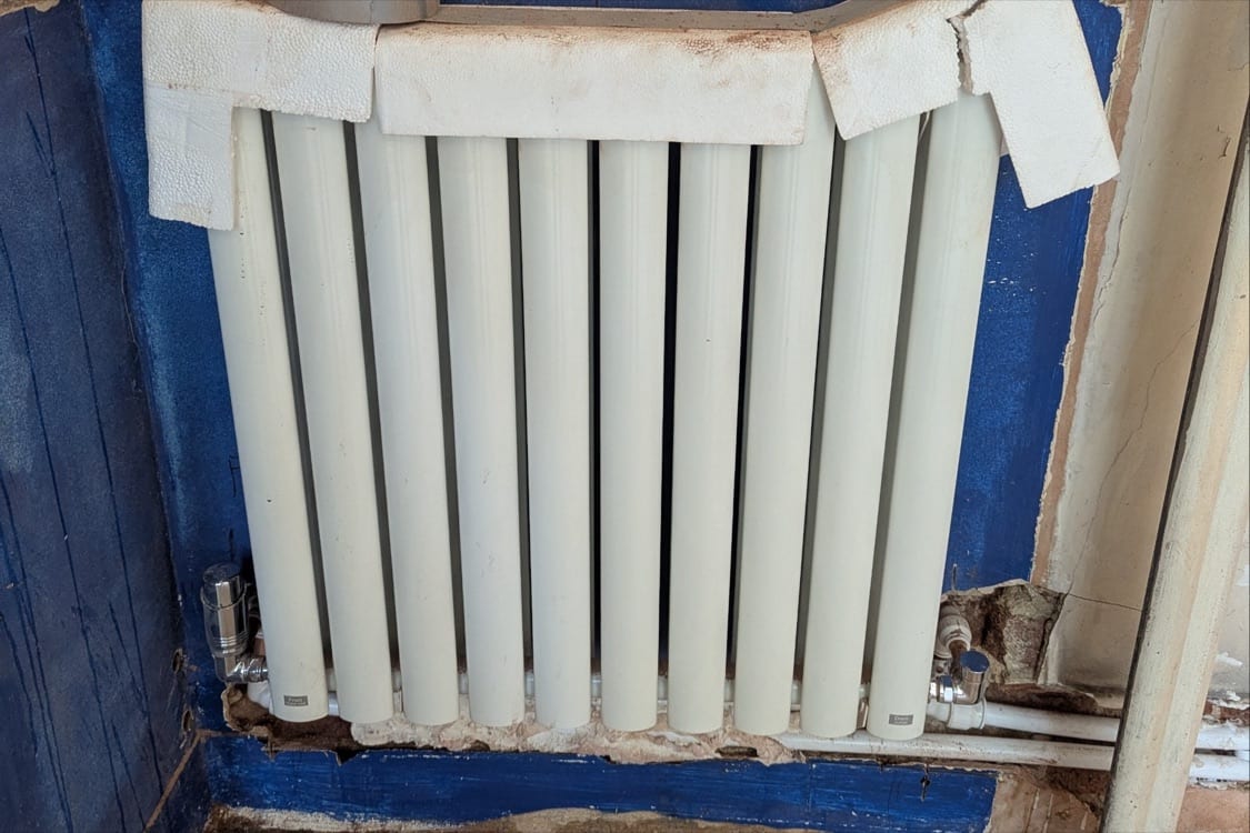 New radiator installed in a bedroom at the Innes Gardens flat during first fix