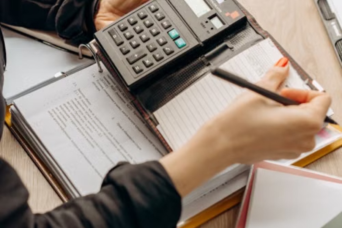 Landlord reviewing property tax documents and calculator