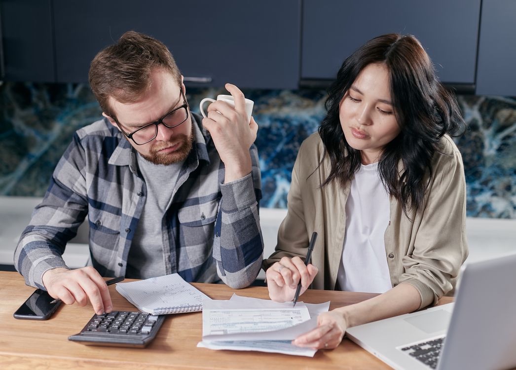 Couple reviewing a down valuation letter and renegotiating a property purchase